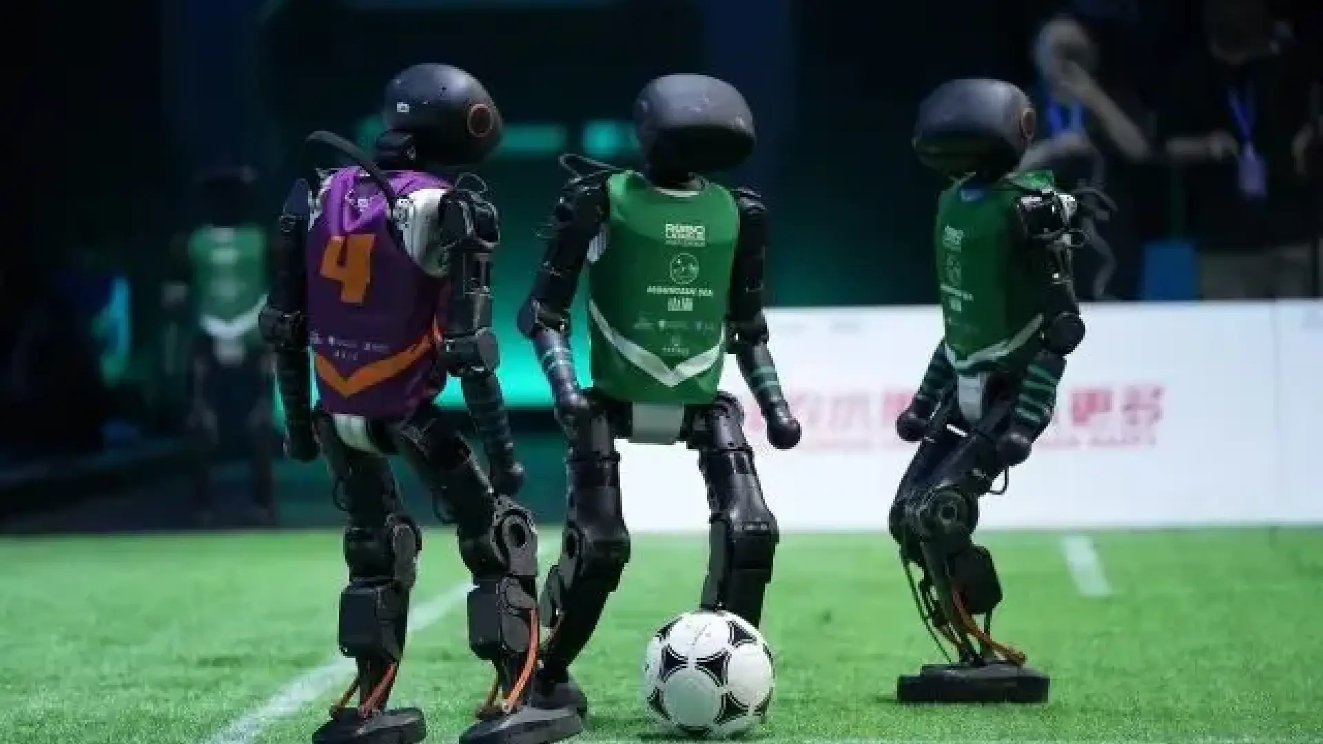 This is a soccer match between humanoid robots that shows there's still a lot to be done: collisions, stumbles, limited mobility...